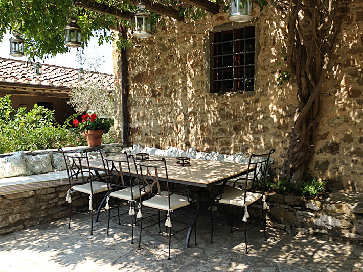 Dining under wisteria pergola